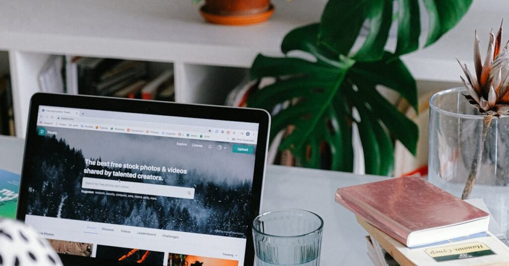 A woman working from home on her laptop surrounded by plants and books for a cozy office feel.